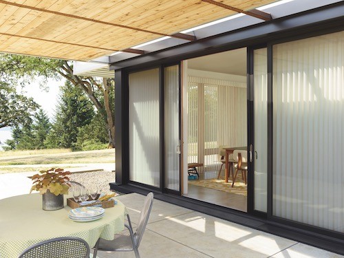 A concrete patio with view into the dining room.